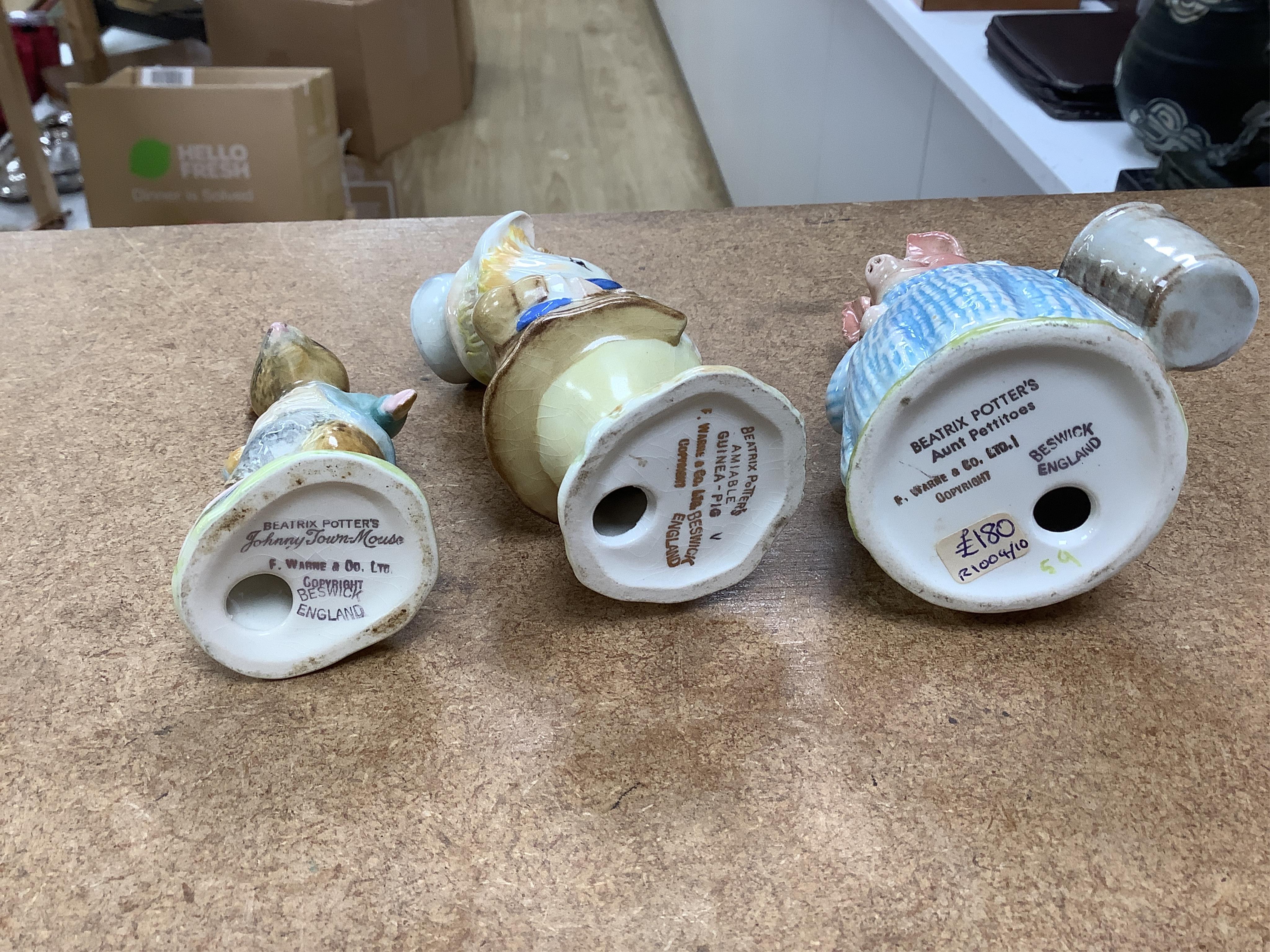 A collection of thirteen Beatrix Potter character figures, stamped with a gold stamp F Warne and Co Ltd, Beswick England, largest 12cm high